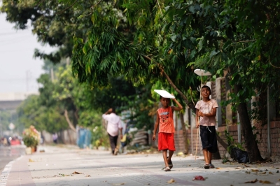 Children hold cork sheets to cover them from the sun while walking along a street during a countrywide heat wave in Dhaka, Bangladesh, on Sunday.