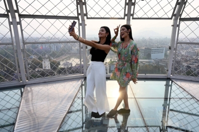 Nepali TikTok influencers and twin sisters Princy (left) and Prisma Khatiwada take a selfie in Kathmandu on Monday.
