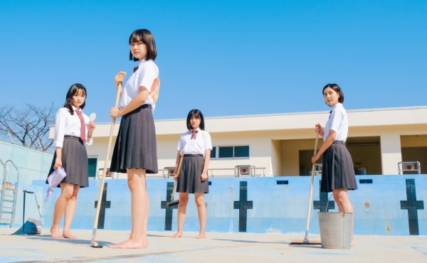 Four girls congregate at an empty swimming pool at their high school and discuss their lives in “Swimming in a Sand Pool.”
