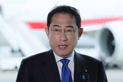 Prime Minister Fumio Kishida speaks to reporters at Haneda Airport in Tokyo on Wednesday before embarking on a trip to France and South American countries.