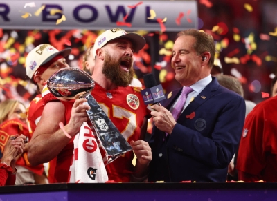 Chiefs tight end Travis Kelce celebrates with the Lombardi Trophy after Super Bowl LVIII in Las Vegas on Feb. 11.
