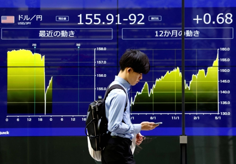An electronic screen in Tokyo displays the yen exchange rate against the U.S. dollar and the graph showing its recent swings, on Thursday.