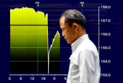 An electronic screen displays a graph showing Japanese yen exchange rates surging against the dollar amid signs of intervention by authorities, in Tokyo on Thursday.