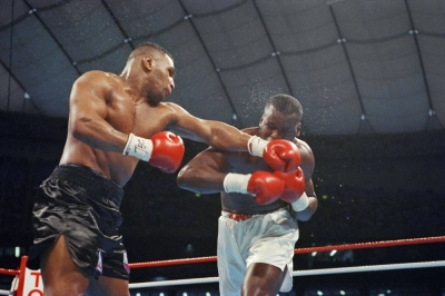 Mike Tyson (left) and Buster Douglas fight during the seventh round of their world heavyweight title fight at Tokyo Dome on Feb. 11, 1990.