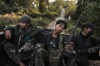 Resistance soldiers ride in the back of a pickup truck in southern Karenni State, Myanmar, on Jan. 28. Three years after a military coup, the Southeast Asian nation is teetering on the brink of failed statehood.
