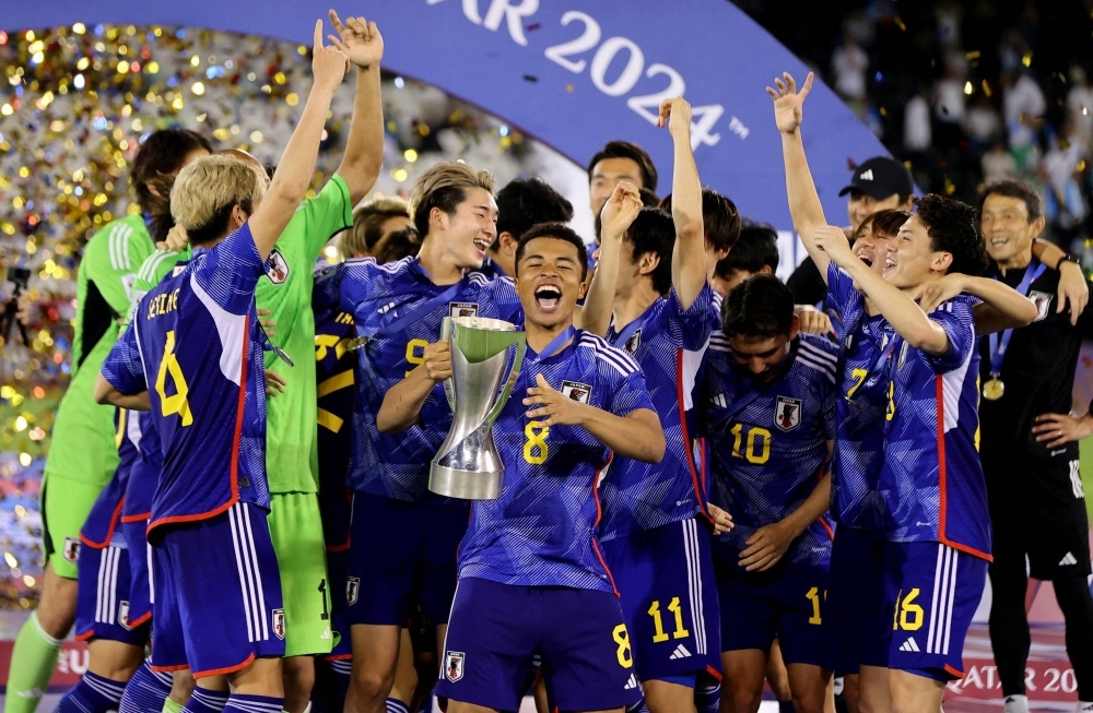Japan players celebrate after beating Uzbekistan in the final of the Under-23 Asian Cup in Doha on Friday. 