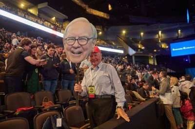An attendee holds a cardboard cutout of Warren Buffett, chairman and chief executive officer of Berkshire Hathaway, inside the CHI Health Center during the Berkshire Hathaway annual shareholders meeting in Omaha, Nebraska, on Saturday.