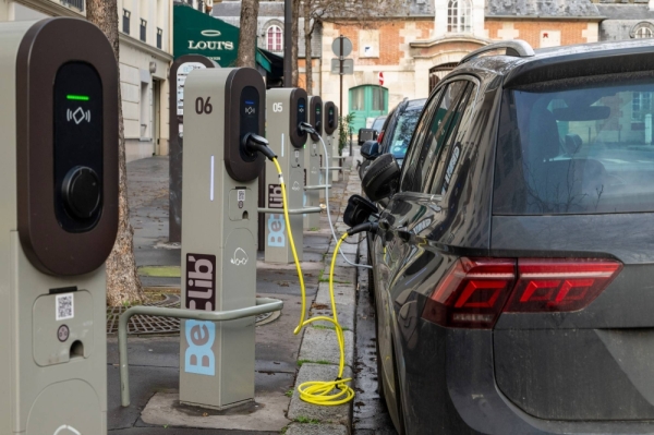 Automobiles charge at public electric vehicle charging stations in Paris on Feb. 14.