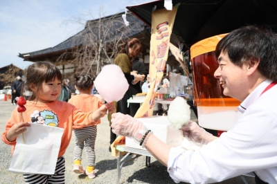 A child receives cotton candy at a free cafeteria opened in the city of Suzu, Ishikawa Prefecture, on March 31.