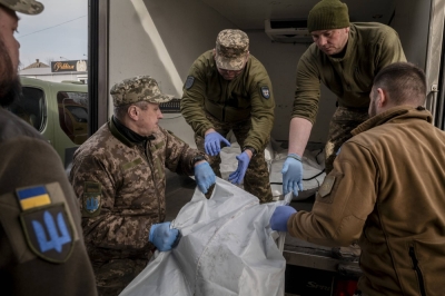 Morgue staff work with members of On The Shield, an organization tasked with collecting bodies of killed soldiers, at a morgue in the Donetsk region, Ukraine, on March 29. Ukraine struggles to name its dead; families of some soldiers say they have spent months trying to get official confirmation of their loved one’s death, adding to their anguish. 