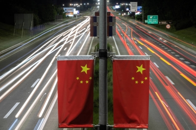 Cars pass Chinese flags on a highway ahead of Chinese leader Xi Jinping's visit in Belgrade, Serbia, on Sunday.