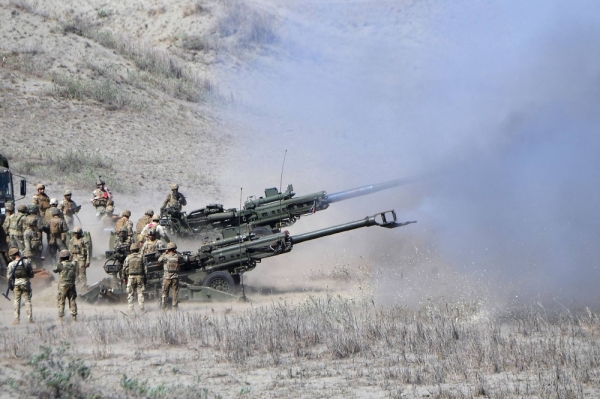 U.S. and Philippine Marines fire M198 155mm Howitzer artillery during a live-fire exercise against an imaginary "invasion" force as part of the joint U.S.-Philippines annual Balikatan military drills on a strip of sand dunes in Laoag on Luzon island's northwest coast on Monday. 