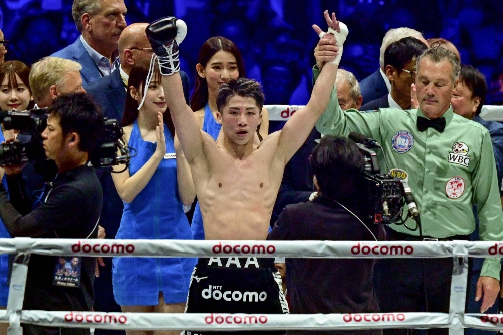 Naoya Inoue celebrates his victory over Luis Nery in their IBF-WBA-WBC-WBO super bantamweight title boxing match at Tokyo Dome on Monday.