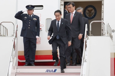 Prime Minister Fumio Kishida arrives at Tokyo's Haneda Airport on Monday after his trip to France, Brazil and Paraguay.