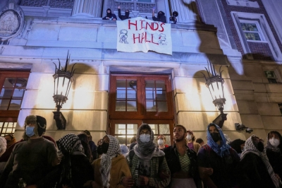 Protesters link arms outside Hamilton Hall barricading students inside the building at Columbia University, despite an order to disband the protest encampment supporting Palestinians or face suspension, in New York on April 30.