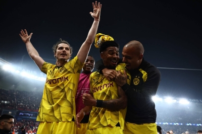 Dortmund midfielder Marcel Sabitzer (left), defender Ian Maatsen (center) and forward Donyell Malen celebrate their team's victory over Paris Saint-Germain in Paris on Tuesday.