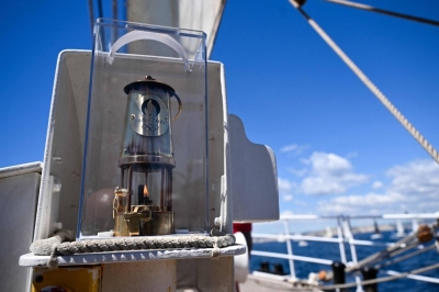 The Olympic flame sits on board the Belem as the boat sails near the coast of Marseille, France, on Wednesday.