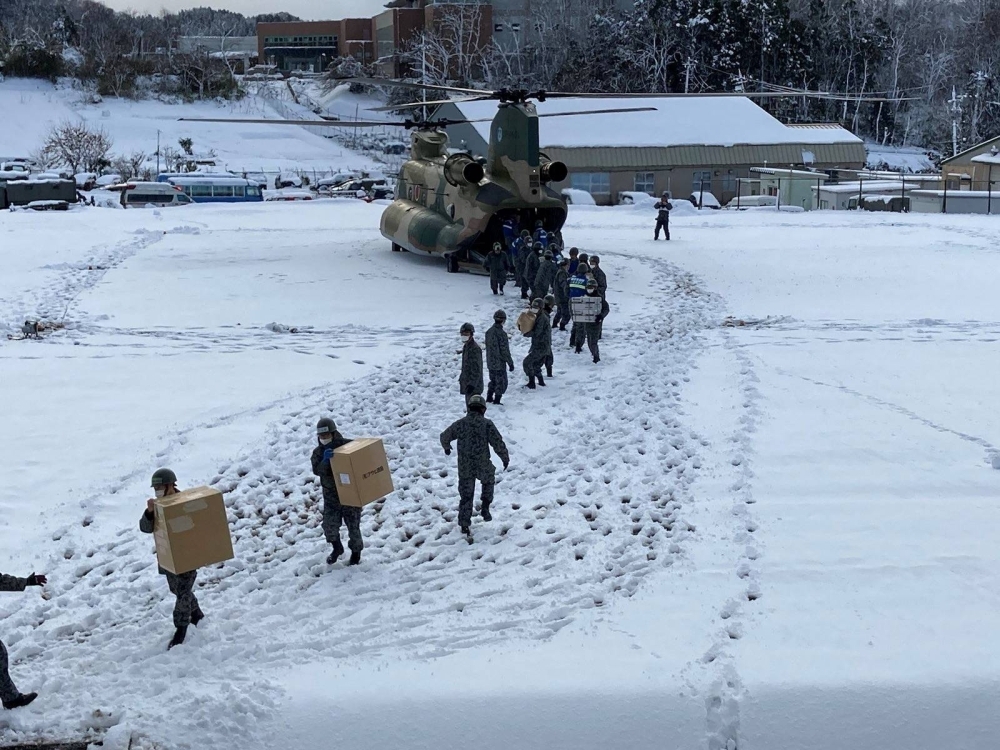 Self-Defense Force soldiers carry relief supplies at an earthquake-hit area in Wajima, Ishikawa Prefecture, on Jan. 8. Researchers have found that the seismic activity on the Noto Peninsula is synchronized with changes in underground pressure, which is influenced by seasonal patterns of precipitation — particularly heavy snowfall. Self-Defense Force soldiers carry relief supplies at an earthquake-hit area in Wajima, Ishikawa Prefecture, on Jan. 8. Researchers have found that the seismic activity on the Noto Peninsula is synchronized with changes in underground pressure, which is influenced by seasonal patterns of precipitation — particularly heavy snowfall.