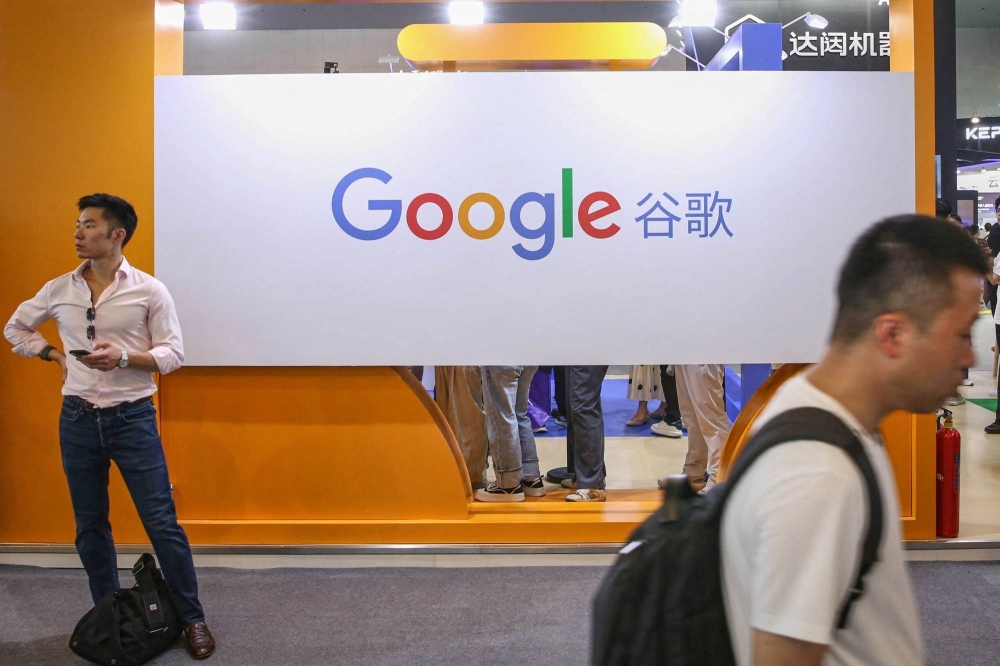 Visitors walk past the logo of Google at its exhibition booth during the World Artificial Intelligence Conference in Shanghai on Friday. Visitors walk past the logo of Google at its exhibition booth during the World Artificial Intelligence Conference in Shanghai on Friday.