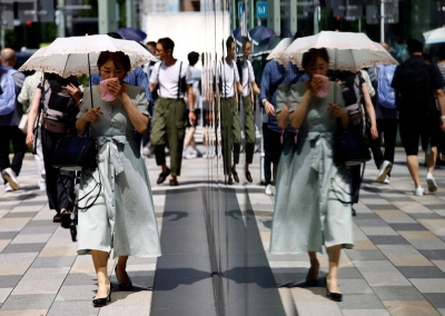 A passerby holding a parasol wipes her face as she walks on the street amid a heatstroke alert in Tokyo and other prefectures, in Tokyo on July 9. A passerby holding a parasol wipes her face as she walks on the street amid a heatstroke alert in Tokyo and other prefectures, in Tokyo on July 9.