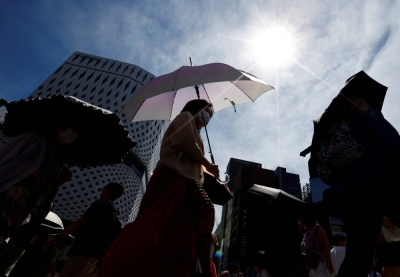 Passersby holding parasols walk through Tokyo on July 9 amid a heatstroke alert in the capital and other prefectures. Passersby holding parasols walk through Tokyo on July 9 amid a heatstroke alert in the capital and other prefectures.