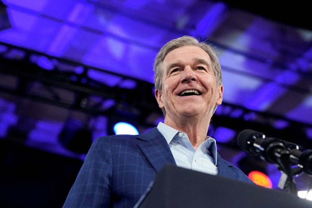 North Carolina Gov. Roy Cooper smiles as he attends U.S. President Joe Biden's rally in Raleigh, North Carolina, on June 28. North Carolina Gov. Roy Cooper smiles as he attends U.S. President Joe Biden's rally in Raleigh, North Carolina, on June 28.