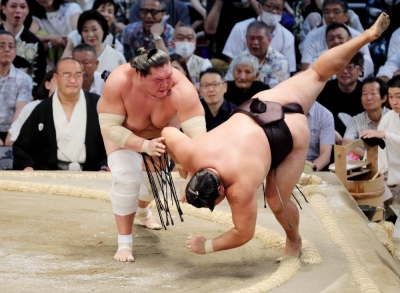Terunofuji (left) throws down Kirishima on Tuesday to build on his perfect record at the Nagoya Grand Sumo Tournament. Terunofuji (left) throws down Kirishima on Tuesday to build on his perfect record at the Nagoya Grand Sumo Tournament.