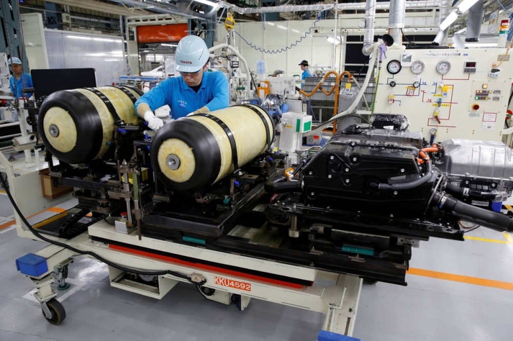 A Toyota employee works on a Mirai fuel cell vehicle at a factory in Toyota, Aichi Prefecture, in 2018. In 2023, nationwide sales of standard-size passenger BEVs rose 39% to 43,991, according to the Japan Automobile Dealers Association, far exceeding the total for FCVs at 422.