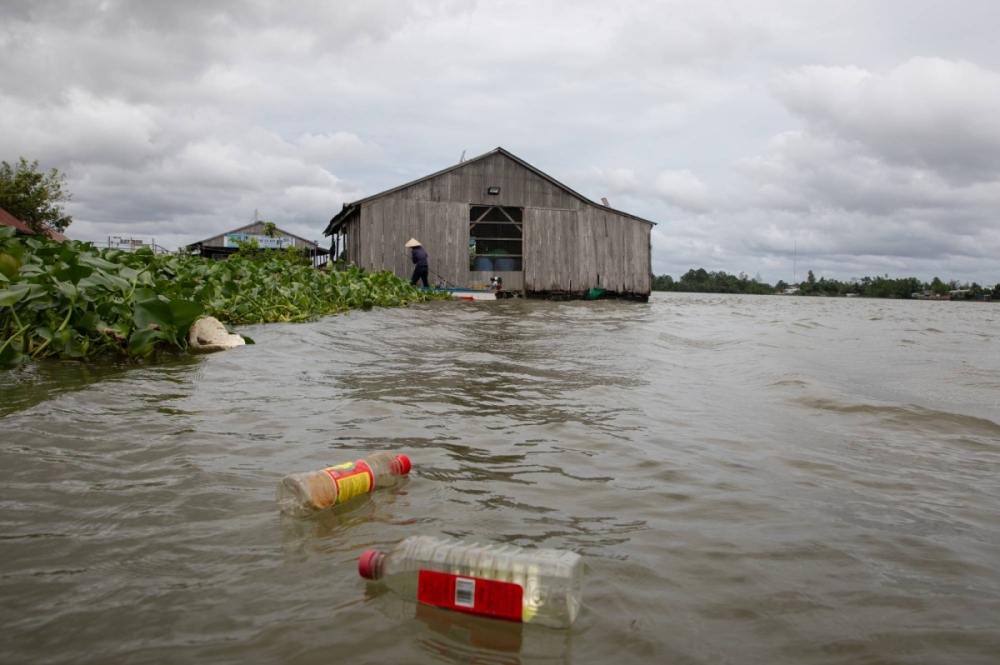 Plastic bottles float in Vietnam's Mekong Delta as a fisherman returns to a dock by Can Tho City, the largest city in Vietnam's Mekong Delta. Plastic bottles float in Vietnam's Mekong Delta as a fisherman returns to a dock by Can Tho City, the largest city in Vietnam's Mekong Delta.