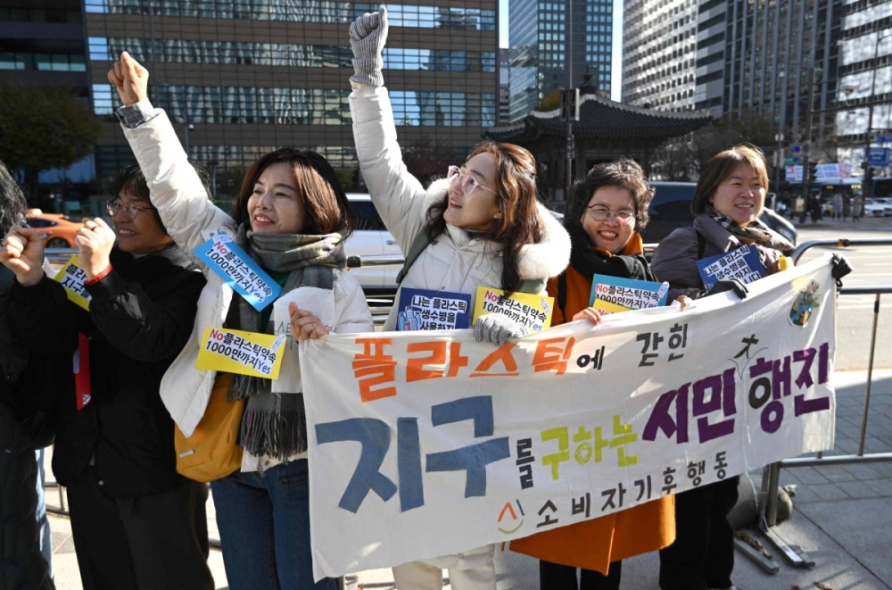South Korean environmental activists hold a banner reading South Korean environmental activists hold a banner reading