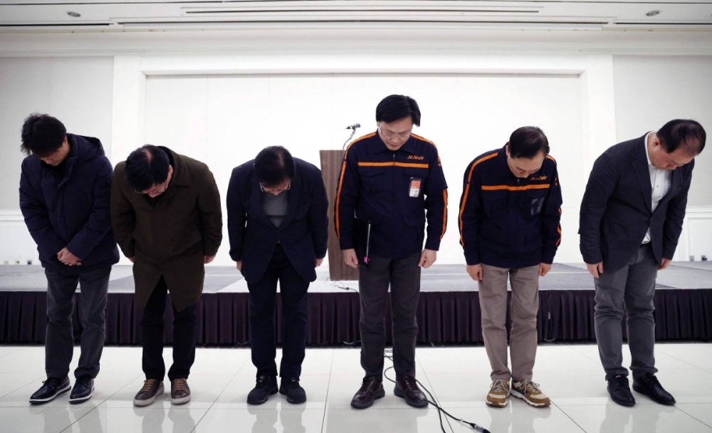 Jeju Air CEO Kim E-bae (third from right) and other executives bow in apology ahead of a briefing in Seoul on Sunday. Jeju Air CEO Kim E-bae (third from right) and other executives bow in apology ahead of a briefing in Seoul on Sunday.