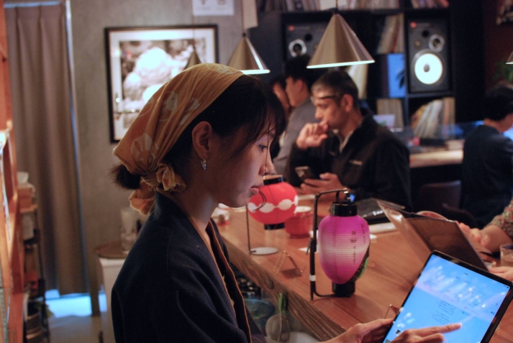 Kazue Maeda, co-founder of Vegan Sushi Tokyo, serves customers at the restaurant, where the recommended lunch set includes a tray of faux-fish sushi.  Kazue Maeda, co-founder of Vegan Sushi Tokyo, serves customers at the restaurant, where the recommended lunch set includes a tray of faux-fish sushi.