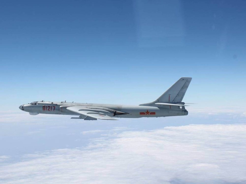 A Chinese H-6 bomber flies between Okinawa’s main island and Miyako Island in October 2013. Former Prime Minister Shinzo Abe warned that Japan must strengthen its defenses in case of a Taiwan contingency.