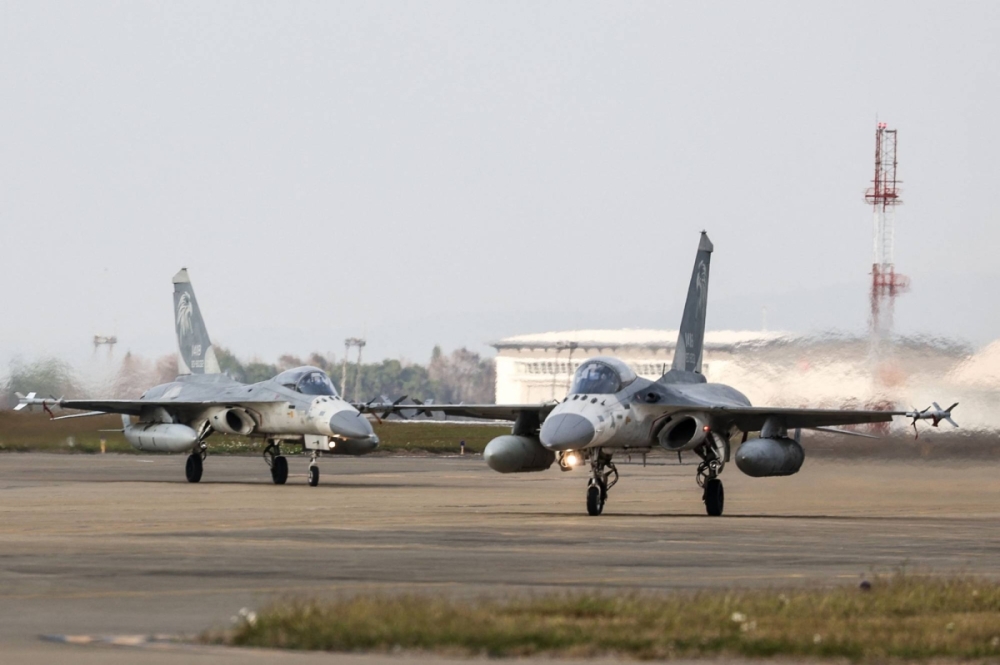 Taiwanese Air Force Indigenous Defense Fighter aircraft taxi for takeoff during a scramble as part of a combat readiness exercise at the Ching Chuan Kang Air Base in Taichung, Taiwan, on Jan. 7.