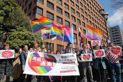 Following the Nagoya High Court ruling on the same-sex marriage lawsuit, lawyers and others raise banners and boards that read "unconstitutional" and similar statements on Friday in Naka Ward, Nagoya. Following the Nagoya High Court ruling on the same-sex marriage lawsuit, lawyers and others raise banners and boards that read "unconstitutional" and similar statements on Friday in Naka Ward, Nagoya.