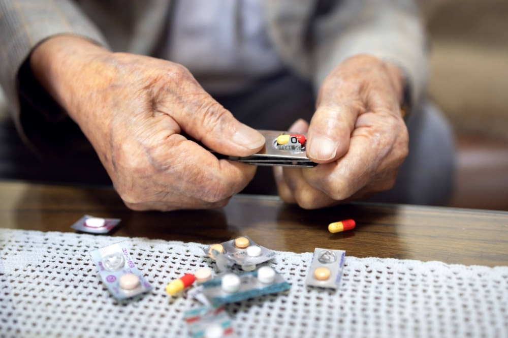 Shinobu Kani shows off a new invention: A patented pill separator that resembles a nail clipper.  Shinobu Kani shows off a new invention: A patented pill separator that resembles a nail clipper.