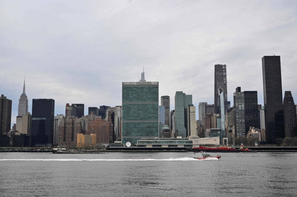 A boat on the East River passes United Nations Headquarters in New York. A boat on the East River passes United Nations Headquarters in New York.