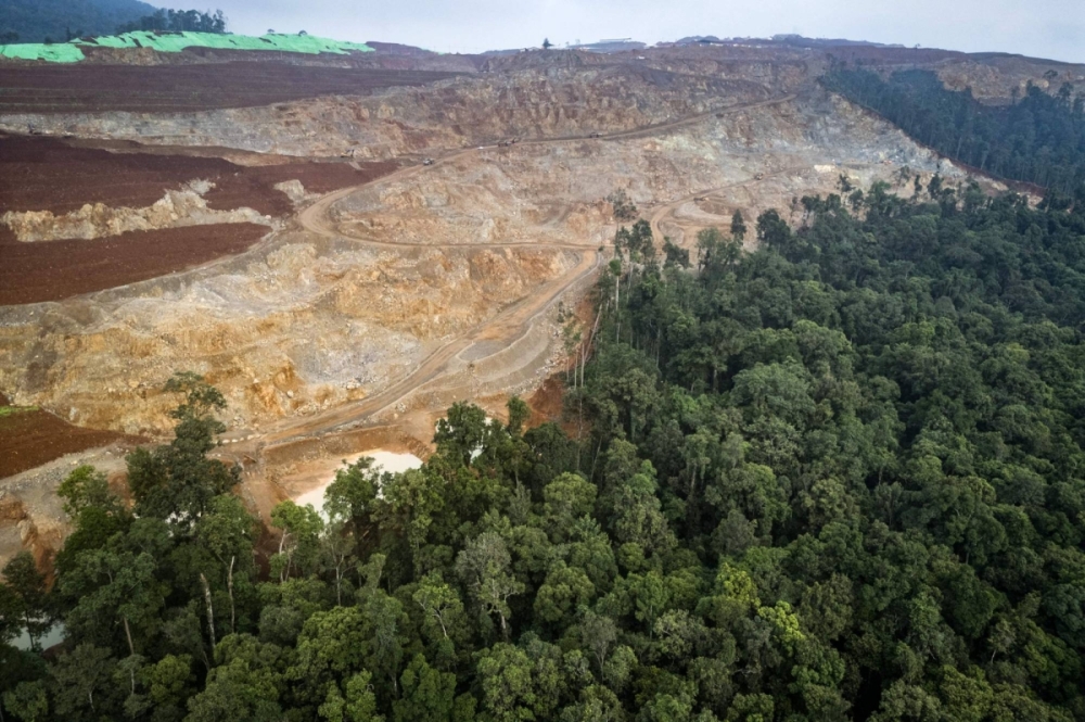 A nickel mining site and the edge of the forest where Bokum, a member of the Hongana Manyawa indigenous tribe, regularly patrols to monitor mining activity in East Halmahera, North Maluku, Indonesia, on April 16. A nickel mining site and the edge of the forest where Bokum, a member of the Hongana Manyawa indigenous tribe, regularly patrols to monitor mining activity in East Halmahera, North Maluku, Indonesia, on April 16.