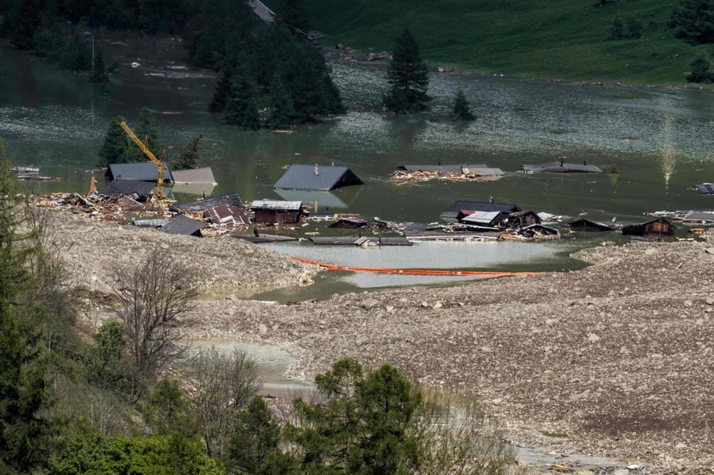 Debris and the rest of the village of Blatten, now submerged by the obstructed river Lonza, after the huge Birch Glacier collapsed and a massive landslide in the Swiss Alps on Saturday. Debris and the rest of the village of Blatten, now submerged by the obstructed river Lonza, after the huge Birch Glacier collapsed and a massive landslide in the Swiss Alps on Saturday.