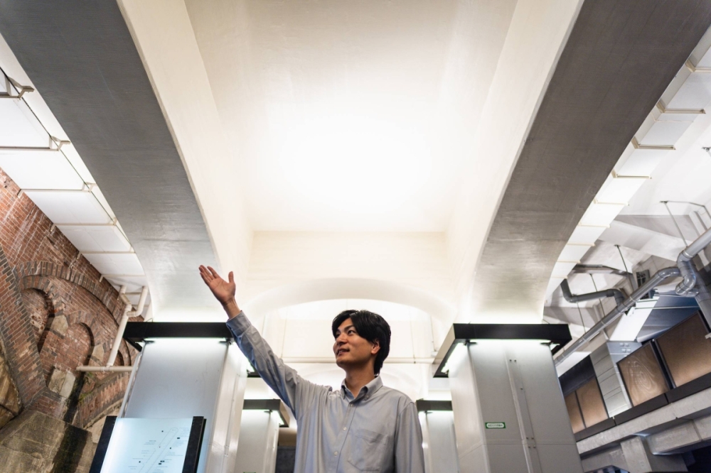 Shin Okubo points to the iconic red arches built in 1910 from the inside of retail complex Hibiya Okuroji. Shin Okubo points to the iconic red arches built in 1910 from the inside of retail complex Hibiya Okuroji.