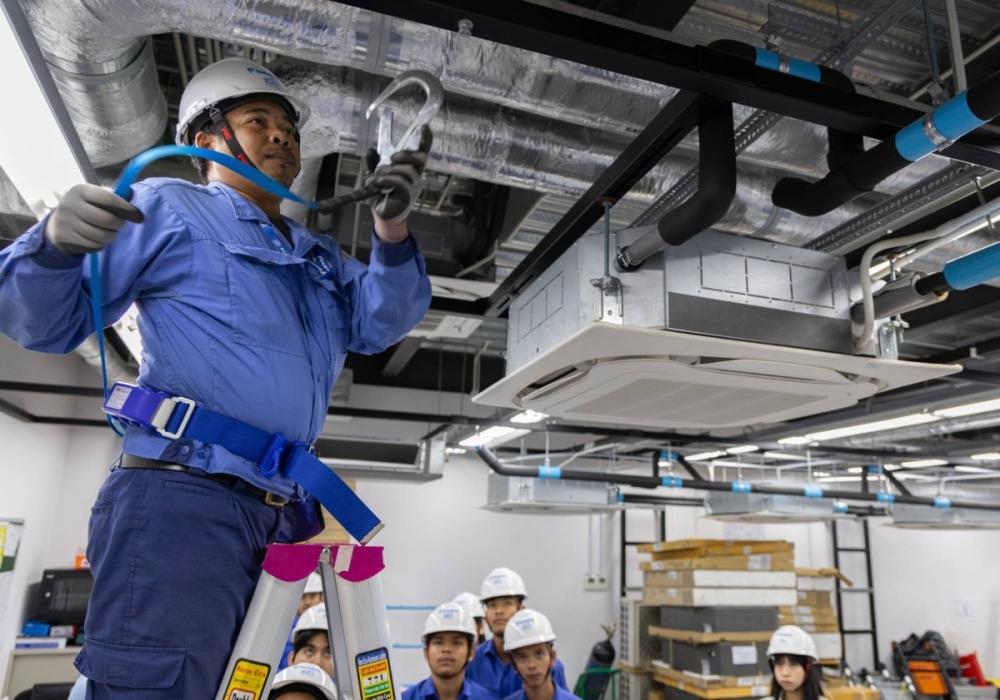 An employee of Daikin Cambodia demonstrates the use of a safety harness during an air conditioner installation training session in Phnom Penh. An employee of Daikin Cambodia demonstrates the use of a safety harness during an air conditioner installation training session in Phnom Penh.