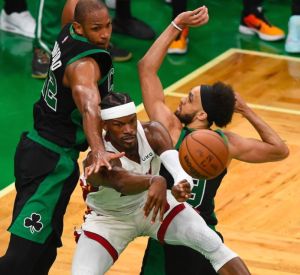 Jimmy Butler of the Miami Heat (center) passes between Al Horford (left) and Derrick White of the Boston Celtics during the second half in Game Six of the 2022 NBA Playoffs Eastern Conference Finals at TD Garden on Friday, May 27, 2022 (May 28 in Manila), in Boston, Massachusetts.AFP PHOTO