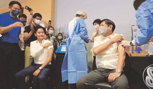 TWOGETHER President Ferdinand Marcos Jr. and son Ilocos Norte Rep. Ferdinand Alexander get a booster shot at SM Manila during the launch of the PinasLakas campaign of the Department of Health. CONTRIBUTED PHOTO