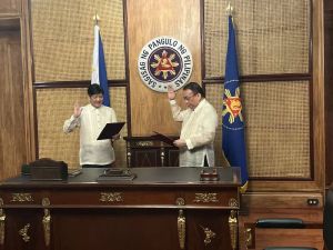 Retired Chief Justice Lucas Bersamin takes his oath as new executive secretary before President Marcos in Malacañang on Tuesday. CONTRIBUTED PHOTO