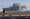 A photographer takes photos near the quarantined Diamond Princess cruise ship anchored at a port in Yokohama, near Tokyo, Friday, Feb. 21, 2020. Passengers tested negative for COVID-19 started disembarking since Wednesday. (AP Photo/Eugene Hoshiko)