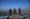 Members of the Taliban stand over a plinth overlooking the Kabul city  at the Wazir Akbar Khan hill in Kabul on January 10, 2022.