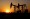 Pumpjacks are seen against the setting sun at the Daqing oil field in Heilongjiang province, China. — Reuters