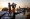 Men deliver food aid, transported overnight in canoes over the floodwater, in Bentiu, South Sudan, early on Feb. 1, 2023.  (Jim Huylebroek/The New York Times)