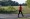 Teo Filip walks while listening to music through her headphones at Eldridge Park, in Elmhurst, Ill., on June 28, 2022. (Yana Paskova/The New York Times)