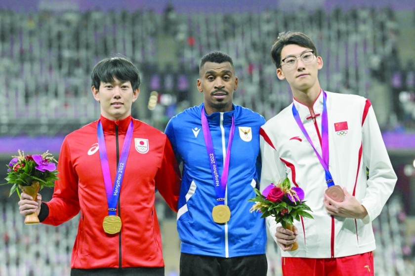 (Left) Men's 110m hurdles gold medalist Toshiya Takayama of Japan and Yakub Juha of Kuwait and bronze medalist Xu Zhuoyi of China celebrate on the podium. --AFP